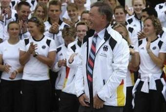 German President Horst Koehler poses with a jacket of the German Olympic team for Beijing 2008 in Berlin July 26, 2008.REUTERS/Michael Dalder(GERMANY)