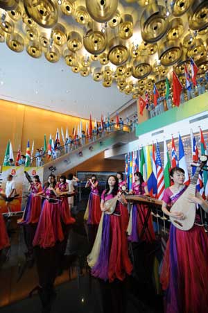 Actors and actresses perform with traditional Chinese musical instruments at the Qingdao Olympic village in Qingdao, the co-host city for sailing events of the Beijing 2008 Olympic Games, in east China's Shandong Province.