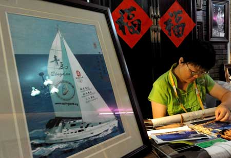 A handicraft artist makes embroidery handicrafts at the folk customs culture exhibition in the Qingdao Olympic village in Qingdao, the co-host city for sailing events of the Beijing 2008 Olympic Games, in east China's Shandong Province, July 27, 2008.