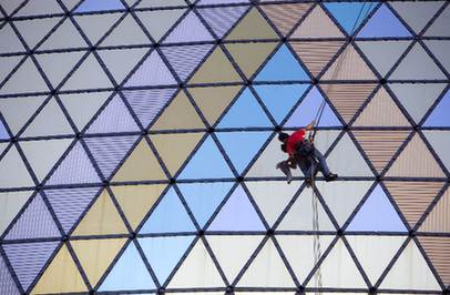 A cleaner abseils down the exterior of the Grand Lisboa Casino in Macao July 25, 2008. Grand Lisboa Casino is one of the gorgeous casinos in Macao.