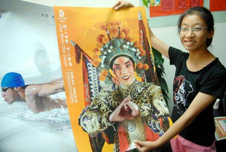 A girl displays her newly-bought Beijing Olympic Games poster in Beijing July 26, 2008.