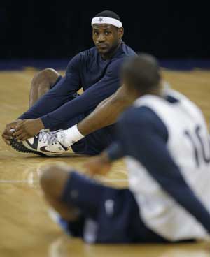 U.S. basketball team players LeBron James (top) and Kobe Bryant stretch during a training session for the Beijing Olympics at the Venetian Macao-Resort-Hotel in Macau on July 29, 2008.