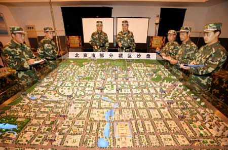 The officers of armed police get familiar with the location of the Olympic stadiums in front of the sand table in Beijing, captial of China, July 28, 2008. The armed police responsible for the security of the Beijing 2008 Olympic Games implement strict training as Olympics near.