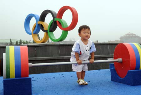 A child plays at the Olympic ground in a residential community in Olympic co-host city Qingdao of east China's Shandong Province, July 28, 2008. Beijing Olympic sailing events will to be held in Qingdao from August 9th to 23rd and the Paralympic sailing events from September 8th to 13th.(Xinhua/Wang Song)