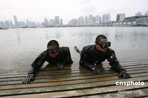 The undated photo shows two divers from the Qingdao Branch of Frontier Defense in drills in the run-up of the Beijing Olympic Games. The sea area where these divers were trained to safeguard security underwater is where the Olympic sailing competition is to be held. Qingdao, east China's Shandong Province is a co-host city of the Beijing Olympic Games. 