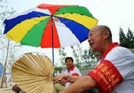 A local resident helps guide directions for passers-by in Beijing July 26, 2008.