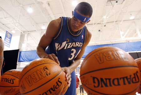 Washington Wizards rookie JaVale McGee signs basketballs during a break at the NBA 2008 Rookie Photo Shoot in Tarrytown, New York, July 29, 2008.