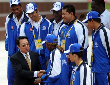 Chen Jian (Front 1st L), mayor on duty of the Olympic Village, shakes hand with members of the Honduran delegation to the Beijing 2008 Olympic Games at Olympic Village in Beijing, China, July 30, 2008. The delegation held flag-raising ceremony at Olympic Village on Wednesday morning. (Xinhua/Li Ga)