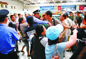 Passengers stranded at Kunming airport scuffled with security guards after their demands for information were not met.