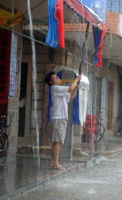 Typhoon Fung Wong weakened into tropical storm early on Tuesday after making landfall in Fuqing, Fujian Province late on Monday. 