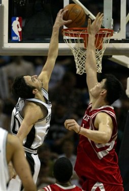 Ginobili (Spurs)  dunks in a game while played by Yao Ming, another top NBA int'l player in the league.