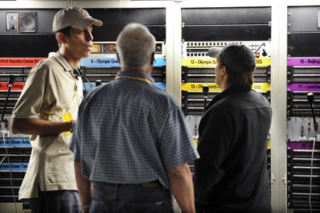 Staff members of the Beijing Olympic Broadcasting Co. Ltd. (BOB) adjust facilities in the International Broadcast Center (IBC) in Beijing, China, July 29, 2008. It’s said that high definition signals will be first-ever used for TV relays for all 28 events of Beijing 2008 Olympic Games. BOB will produce live TV signals of 5,400 hours for right-holding broadcasters and it’s estimated that more than four billion viewers will enjoy the olympic competition through TV broadcasts in 2008. (Xinhua/Li Ziheng)