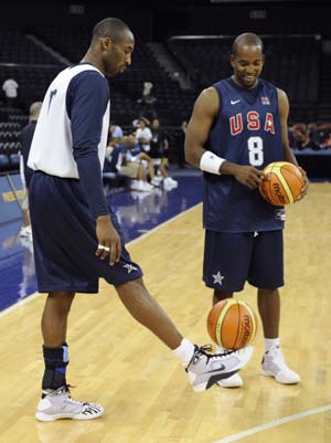 U.S. basketball team player Kobe Bryant (L) controls the ball with his foot while team mate Michael Redd looks at him during a training session for the Beijing Olympics at the Venetian Macao-Resort-Hotel in Macau July 30, 2008.