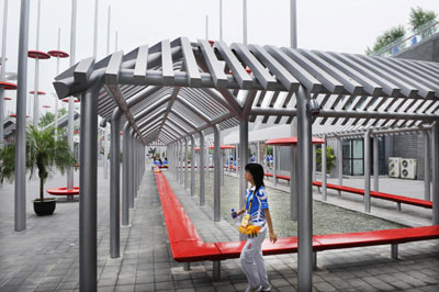 A volunteer walks through a hall in the underground square of the Olympic Green in Beijing July 28, 2008. Located to the north of the Bird's Nest, the underground square gives a presentation of Chinese culture. 