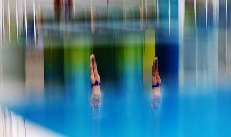 Members of the British Olympic diving team practice during a training session at the National Aquatic Center or 'Water Cube' in Beijing, July 30, 2008. The venue will host the swimming, diving and synchronized swimming events for the 2008 Olympic Games. 