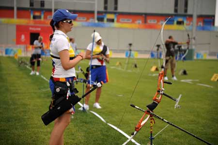 Archer Natalia Sanchez (L) of Colombia takes part in a training session at the Olympic Green Archery Field in Beijing, China, July 31, 2008. Archers started their applicability training sessions after their arrivals in Beijing. (Xinhua/Zhang Ling)