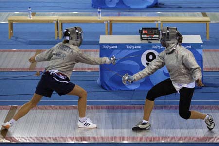 Members of the Ukraine national fencing team practise during a training session inside the Fencing Hall of National Convention Center, in Beijing July 30, 2008. The venue will host the Fencing and Modern Pentathlon (fencing and shooting) at the Beijing Olympic Games. 