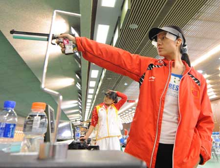 Chinese air pistol shooter Ren Jie practises during a training at the Beijing Shooting Range in Beijing, capital of China, July 31, 2008.