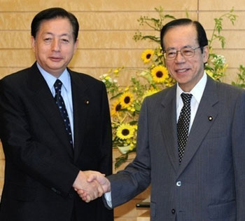 Japanese Prime Minister Yasuo Fukuda (right) shakes hands with coalition partner New Komeito party leader Akihiro Ota prior to their talks at Fukuda's office in Tokyo.