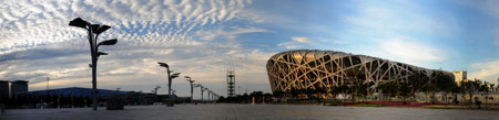 The National Stadium, also known as the Bird's Nest, is seen over a man-made lake at the Olympic Green, against the backdrop of the blue sky in Beijing, August 1, 2008.