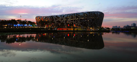 The National Stadium, also known as the Bird's Nest, is seen over a man-made lake at the Olympic Green, against the backdrop of the blue sky in Beijing, August 1, 2008.