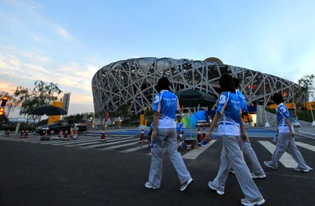 The National Stadium, also known as the Bird's Nest, is seen over a man-made lake at the Olympic Green, against the backdrop of the blue sky in Beijing, August 1, 2008.