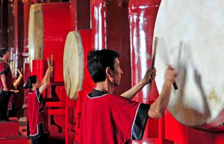 Performers beat drums at the second floor hall in Drum Tower in Beijing, capital of China, Aug. 3, 2008. Bells and Drums were used by the ancient Chinese to tell times. 