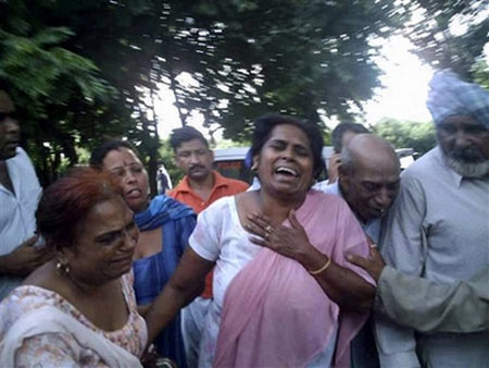 Relatives react outside Anandpur Sahib Civil hospital in Himachal Pradesh, India, where the dead and injured of a temple stampede were taken Sunday, August 3, 2008. 