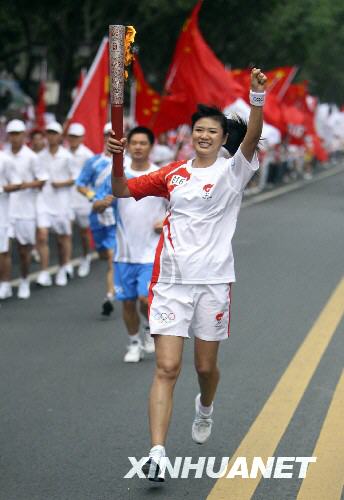 Torchbearer Feng Huang runs with the Olympic torch in Leshan, Sichuan Province August 4. 