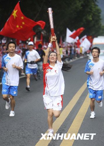 Torchbearer Wang Ting carries the Olympic torch in Leshan, Sichuan Province August 4.