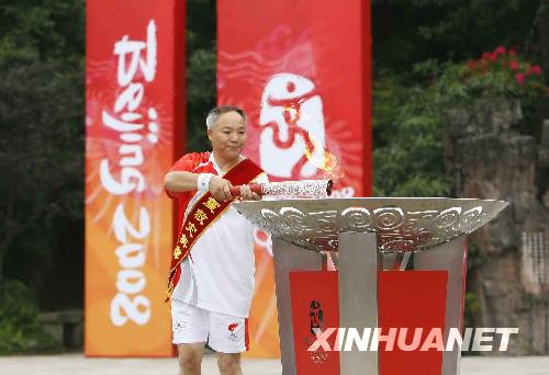 Tan Guoqiang, a hero in the Sichuan earthquake rescue and relief mission lights the cauldron in Leshan Sichuan Province August 4. 