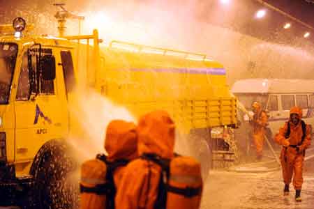 Firefighters take part in a fire drill at a tunnel on the highway linking Hefei and Mount Huangshan in east China's Anhui Province, Aug. 3, 2008.