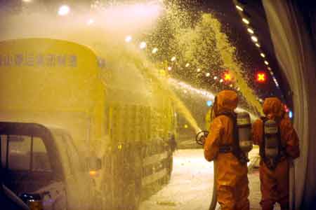 Firefighters take part in a fire drill at a tunnel on the highway linking Hefei and Mount Huangshan in east China's Anhui Province, Aug. 3, 2008. 