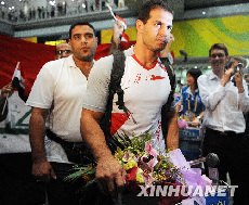 Iraqi athletes walk out of the Beijing Capital International Airport at the midnight of August 4.
