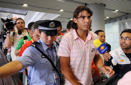 Spanish tennis player Rafael Nadal is chased by reporters at the Beijing Capital International Airport in Beijing, China, Aug 4, 2008. 