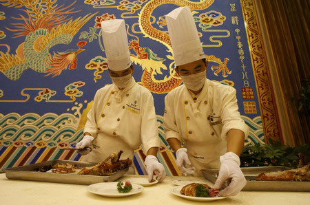 Roast duck is prepared at Quanjude restaurant in Beijing on Monday, August 4, 2008. 