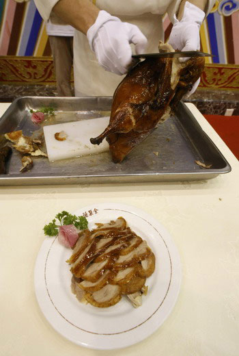 Roast duck is prepared at Quanjude restaurant in Beijing on Monday, August 4, 2008.
