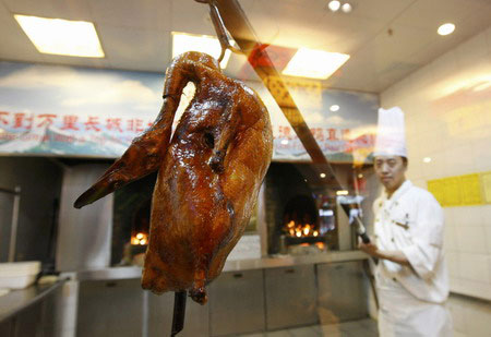 Roast duck is prepared at Quanjude restaurant in Beijing on Monday, August 4, 2008. 