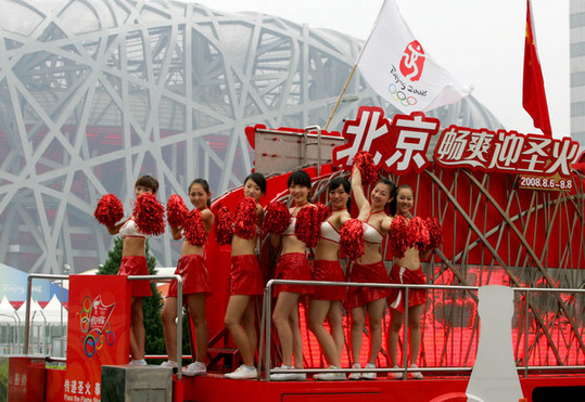 Cheerleaders dance on a Coca-Cola float August 4 near the National Stadium. The float had spent the previous 97 days traveling around China promoting the Olympics. It will join the Beijing leg of the torch relay August 6. [ChinaFotoPress]