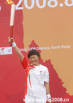 The first torchbearer Zhang Shan displays the torch during the Torch Relay in Chengdu, Sichuan Province, on August 5, 2008.