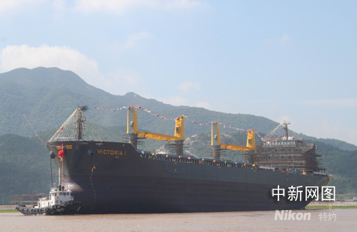 An ocean bulk cargo ship with capacity of 55,000 tons is launched in Taizhou in eastern China's Zhejiang province on Sunday, August 3, 2008.