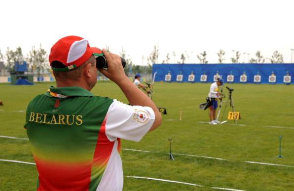 Archery coach from Belarus is observing his archers.