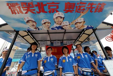 Volunteers prepare for providing services at a street stall in Niujie street in Beijing, capital of China, July 23, 2008. 
