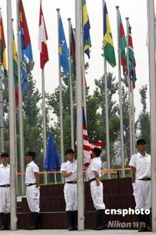 Delegation from Malaysia raises national flag.