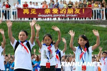 The quake-hit Chinese students wave their hands to their Russian friends and teachers at the 'Ocean' All Russia Children's Center, Russia, Aug. 4. About 200 visiting students from China's quake-hit Sichuan Province winded up their vacation in Russian and set out home. Some 1,000 students from China's quake-affected provinces have arrived in Russia since July 17 for three-week rehabilitation programs.