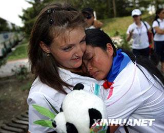 A Russian counselor and a Chinese girl hug at the 'Ocean' All-Russia Children's Center, Russia