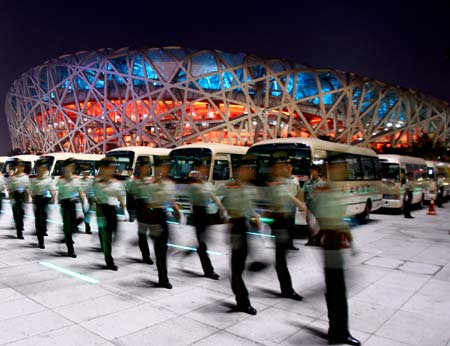 A team of armed policemen patrol outside the National Stadium, nicknamed the Bird&apos;s Nest, in Beijing, China, Aug. 5, 2008. A dress rehearsal of the opening ceremony of Beijing 2008 Olympic Games was held on Tuesday. (Xinhua/Chen Jianli) 