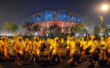 Actors of the opening ceremony walk outside the National Stadium, nicknamed the Bird&apos;s Nest, in Beijing, China, Aug. 5, 2008. A dress rehearsal of the opening ceremony of Beijing 2008 Olympic Games was held on Tuesday. (Xinhua/Yang Lei) 