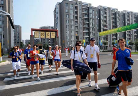 Athletes arrive at the residential area of Olympic Village in Beijing, capital of China, Aug. 5, 2008. The Olympic Village, located in the Olympic Green in north Beijing and divided into three sections of the international area, residential area and operations area, houses about 16,000 athletes, coaches and their entourage from over 200 countries and regions coming for the Olympics. (Xinhua/Zhang Guojun)