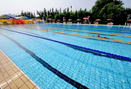 The Olympic Village, located in the Olympic Green in north Beijing and divided into three sections of the international area, residential area and operations area, houses about 16,000 athletes, coaches and their entourage from over 200 countries and regions coming for the Olympics. (Xinhua/Zhang Guojun) 